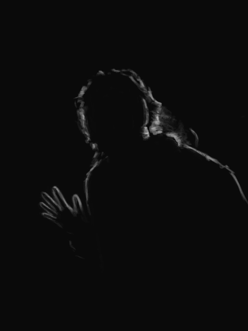 a silhouette of someone slightly crouched with their hand up