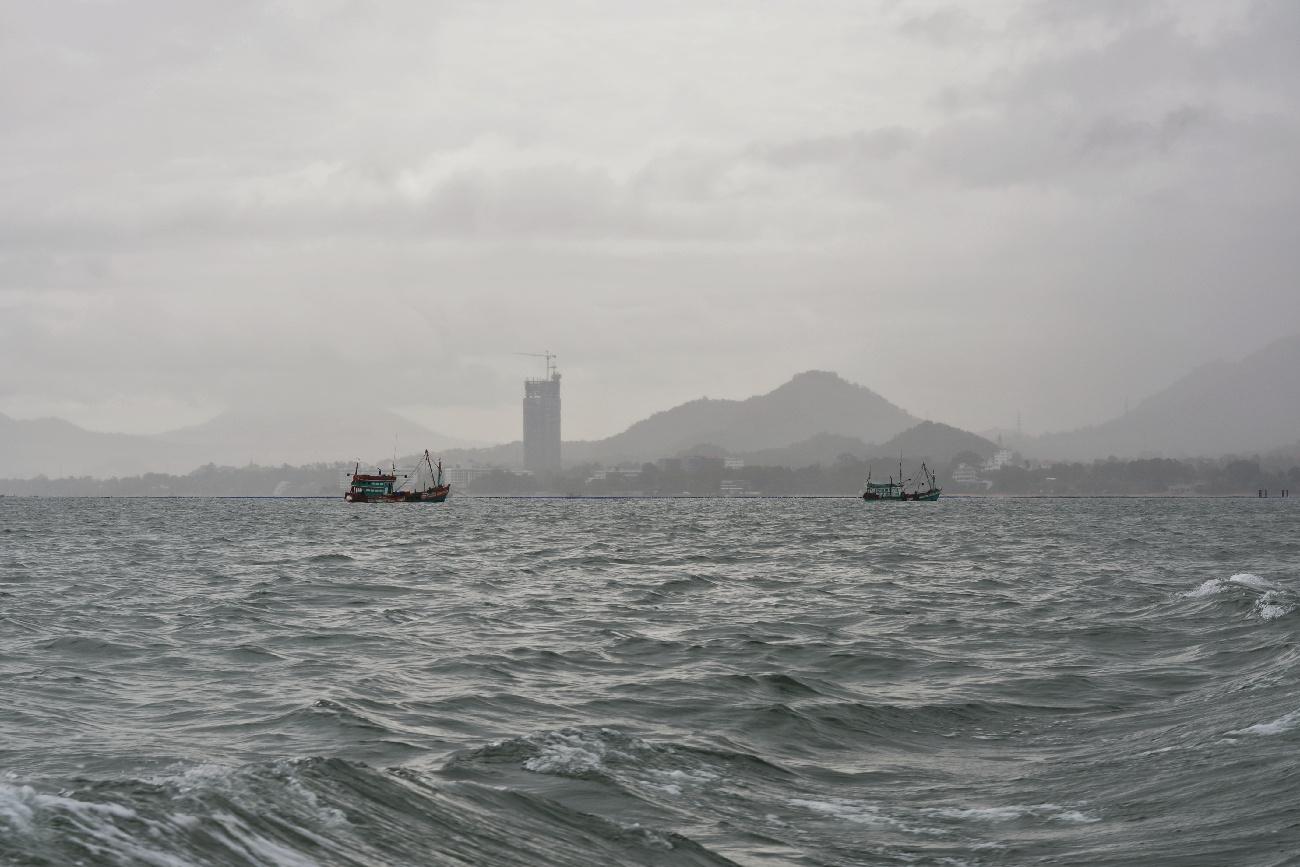 two boats sailing on a rainy day in the Gulf of Thailand