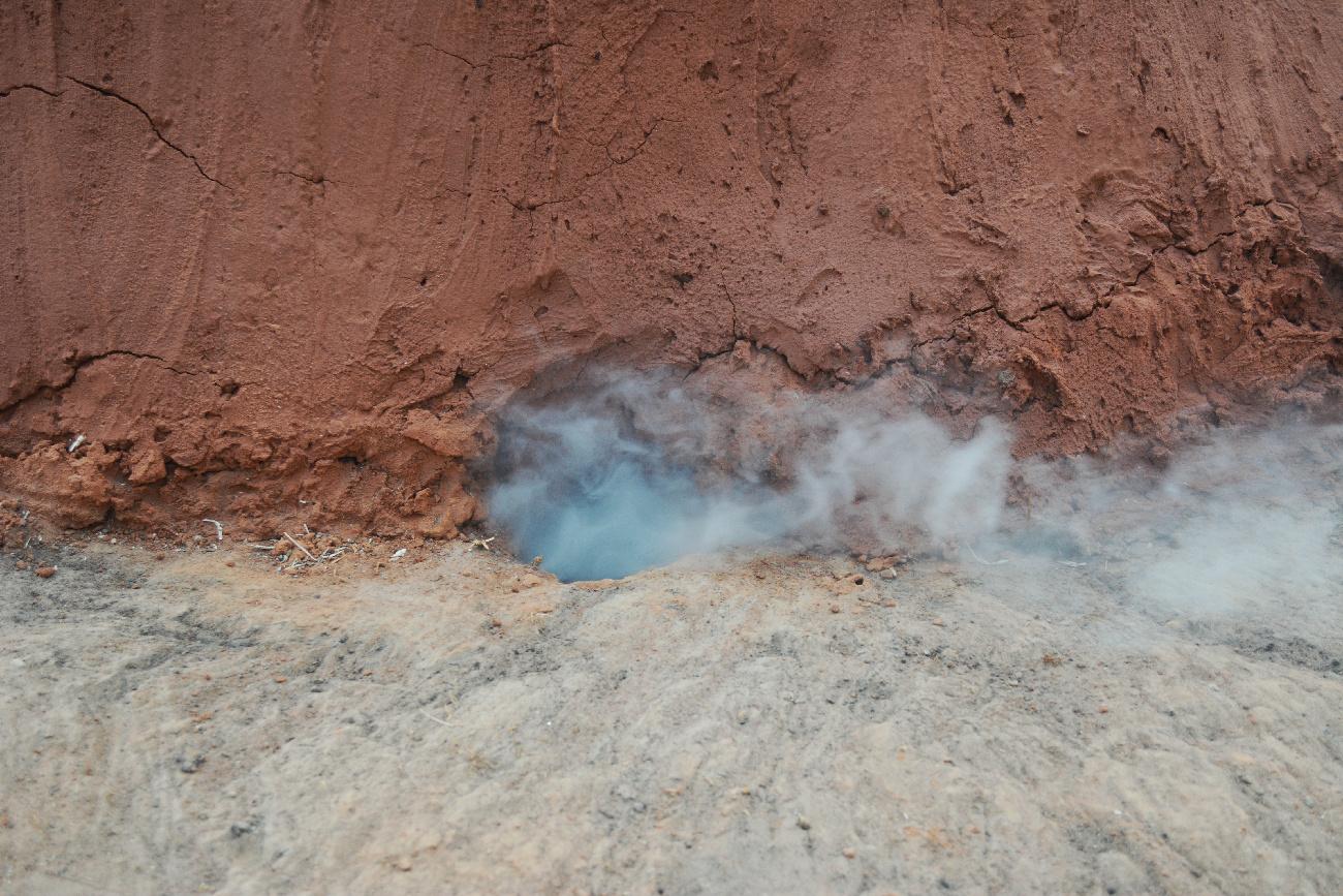 smoke coming out of a charcoal kiln