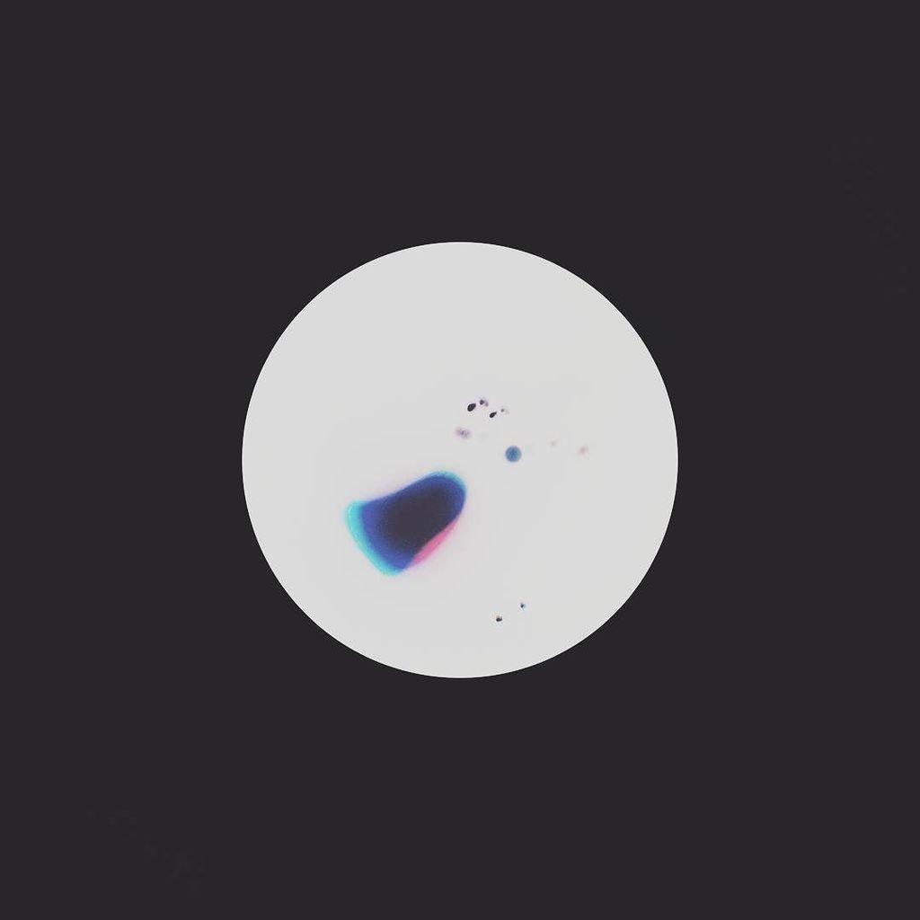 a white circle with colourful specks and blobs