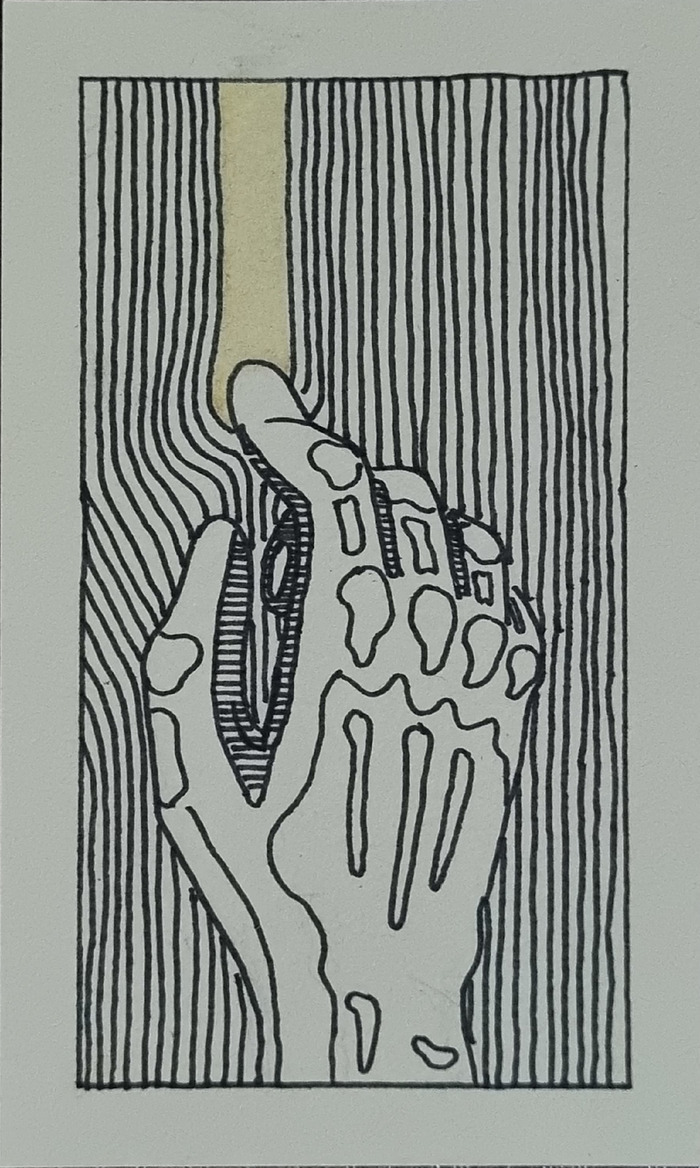 a hand dragging a finger along a surface and revealing a golden layer beneath