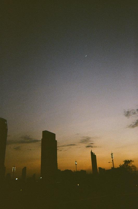 a sunset sky silhouetting a cityscape