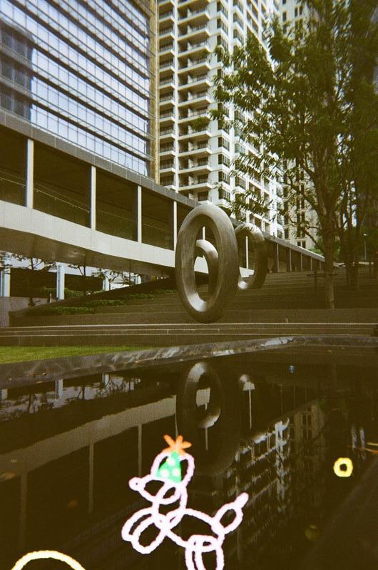 three oval-shaped sculptures reflected in a small pool of water